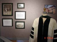 Commencement gown with photographs in background