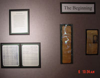Presidential documents mounted on wall display.