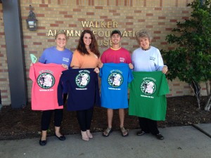 Models holding pig pickin t-shirts