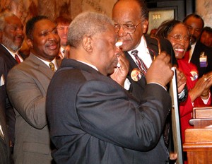 An emotional King is surrounded by Mississippi legislators in Jackso, Miss. as he is presented with a concurrent resolution naming Feb. 15, 200, as B.B. King Day.  (Photo credit: Mississippi Blues Commission)