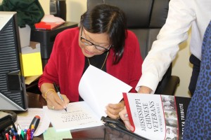 Gwen Gong signs her WWII book.