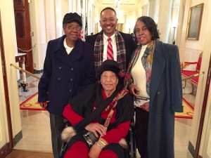 Annyce Campbell, seated, poses in the White House with her daughters Alma Campbell and Emily Harris, as well as Dr. Rolando Herts, director of the Delta Center for Culture and Learning.