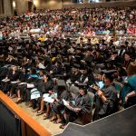 A full theater of people at the Bologna Performing Arts Center for a commencement ceremony.