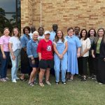 a group of educators standing outside Caylor-Walters Hall